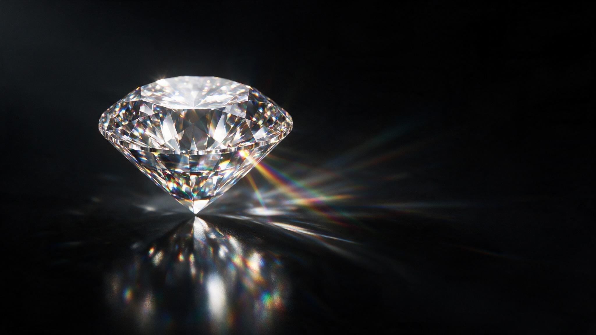 Single round brilliant cut diamond with dramatic light dispersion on black background