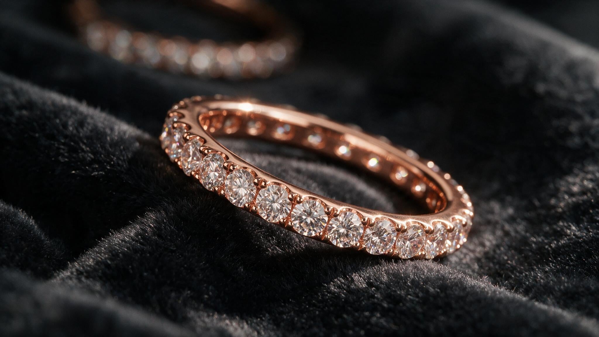 Full diamond eternity ring band catching light on dark velvet